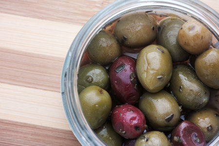 Halkidiki and kalamata olives with some oregano spices in a jar. Close up.の写真素材