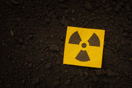 A radiation warning sign on a background of soil. Close up.の写真素材