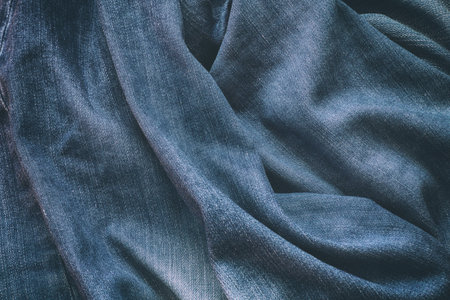 A background of blue crumpled denim jeans. Close up.の写真素材