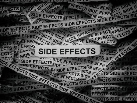 Strips of newspaper with the words Side Effects typed on them. Black and white.