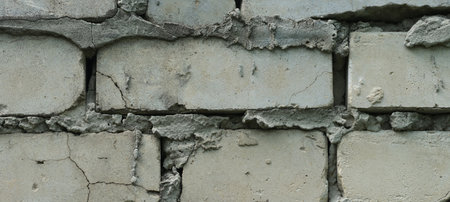 An old shabby red brick wall background. Close up.