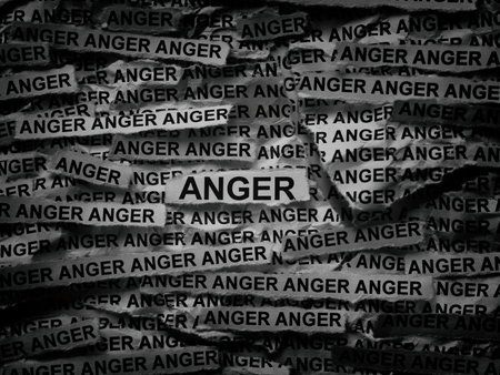 Strips of newspaper with the words Anger typed on them. Black and white. Close up.の写真素材