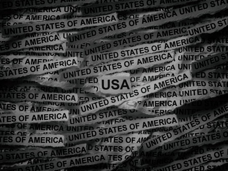 Strips of newspaper with the words United States of America typed on them. Black and white. Close up.の写真素材