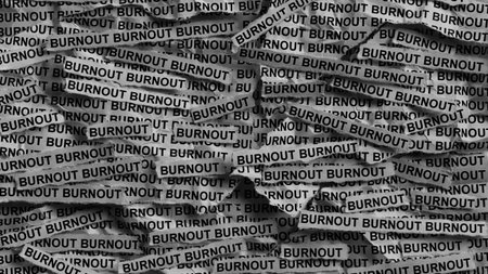 Strips of newspaper with the words Burnout typed on them. Black and white. Close up.の写真素材