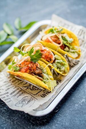 Three mexican tacos in a metal trayの写真素材