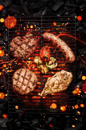 Beef steak on grill grate with sparksの写真素材