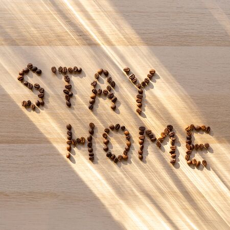 Inscription stay home with coffee beansの写真素材