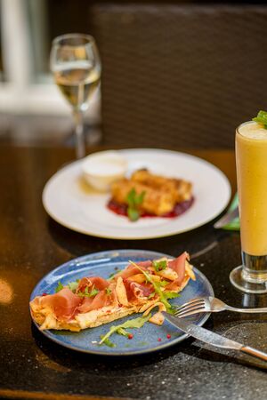 Breakfast with bruschetta and smoothie and glass of wineの写真素材