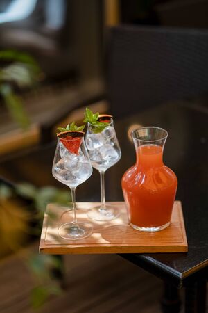 Grapefruit lemonade with glasses on wooden boardの写真素材