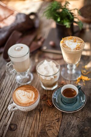 Coffee latte cappuccino espresso on wooden table in summer daylight  cafe restaurant bokeh