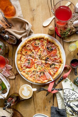 Italian pizza with olive oil and towel on cafe restaurant table top view daylightの写真素材