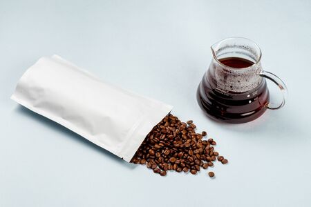 pack with coffee beans and serving kettle with hoy black coffee side view
