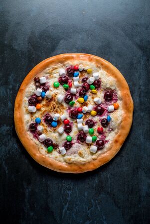 Dessert italian pizza with sauce candy and marshmallows top viewの写真素材