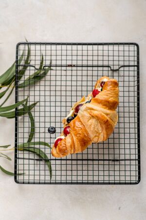 Croissant with berries with leaf grate cafe restaurant cuisine daylight top viewの写真素材