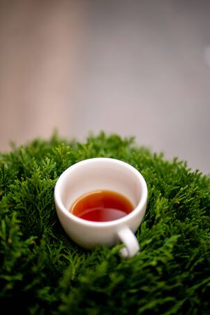Cup of black filter coffee on the grass nature street cafe pour over alternative side viewの写真素材