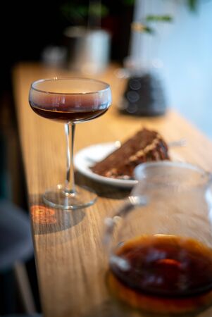 Pour over black coffee hario with cake on table coffee house cafe serving kettle side viewの写真素材