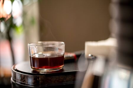 Glass of black filter coffee hario pour over sunlight daylight coffee house cafe side viewの写真素材