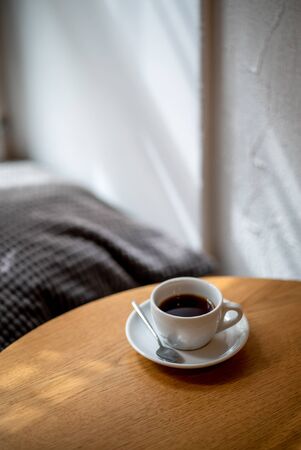 cup of black filter coffee on the table in coffee house cafe coffeebreak sunlight daylight side view
