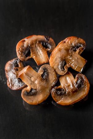 Mushroom champignon grill grilled black background kitchen cooking topping top viewの写真素材