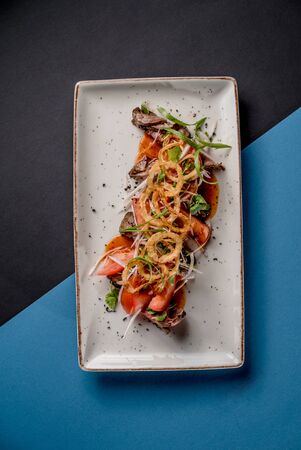 Salad roast beef crispy onion tomato meat mocrogreen greens top viewの写真素材