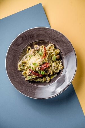 Pasta italian cuisine vegetables tomato mushrooms greens cooking cheese parmesan top viewの写真素材