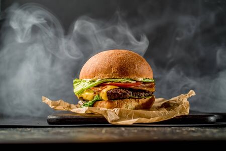 Beef burger american cuisine tomato bbq meat cooking cafe restaurant smoke side viewの写真素材