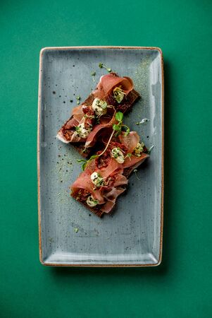 Toast with ham cheese spices microgreen meat plates dish cuisine plate top viewの写真素材