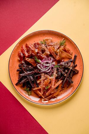 Plate with dried salted fish salmon snack pub restaurant spicy top view dish cuisineの写真素材