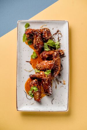 plate chiken wings teriyaki grill fried sauce mint microgreen pub cuisine top viewの写真素材