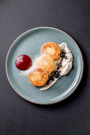 Cheese pancakes with jam sauce grape cream sugar cuisine topping delicious top view daylightの写真素材