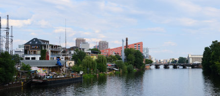 Berlin, Germany, June 28, 2021, view from the Michael Bridge in the direction of Friedrichshain of the fast-growing neighborhood on the Spree River.のeditorial素材