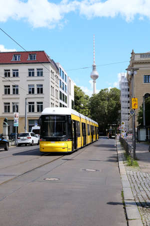 Berlin, Germany, August 8, 2021, waiting streetcar in DorotheenstraÃŸe with TV tower in the...