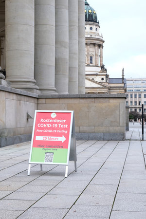 Berlin, Germany, Jan. 22, 2022, sign for free Covid-19 test at Gendarmenmarkt with French cathedral in the background (focus on the sign)のeditorial素材