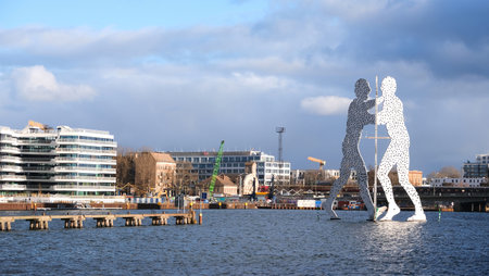 Berlin, Germany, February 2, 2022, view over the river Spree to Molecule Man and Osthafen in front of ElsenbrÃ¼cke bridgeのeditorial素材