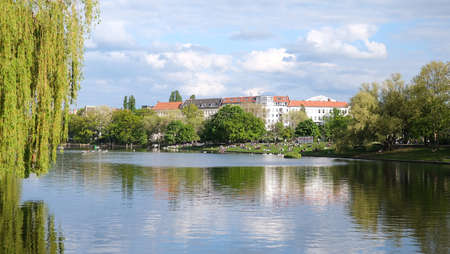 Berlin, Germany, early summer view over the Landweh canal at the Urban harbor to the trees and...