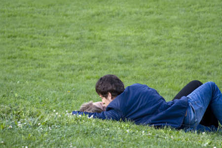 Couple of lovers kissing in the grassの写真素材