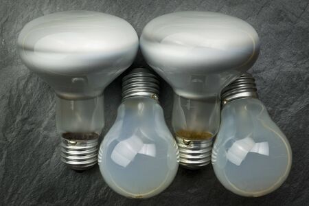Bunch of light bulbs on a grey background.の写真素材