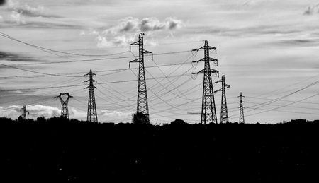 electric pylon and power lines with cloudy sky