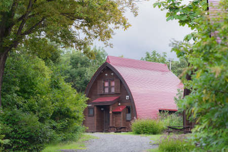 Iiyama, Nagano / JAPAN - SEPTEMBER 2, 2018: spending a night in the mountains, cute wooden cabins in the forest at Mori-no-ie in Nabekura Kogen.のeditorial素材