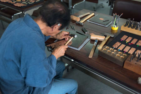 Iiyama, Nagano / JAPAN - SEPTEMBER 2, 2018: Visit at Washimori Metal WorksIiyama's butudan, handcrafted Buddhist shrines, are fitted with intricately worked copper and brass fittings. Try your hand at metalwork through a hands-on workshop!のeditorial素材