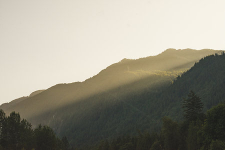 Mountain landscape with fog and sunbeams in the morning in British Columbia, Canada.