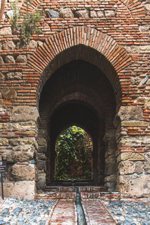 Malaga, Spain - May 24 2019: Old stone archway in an ancient building in Spain.のeditorial素材
