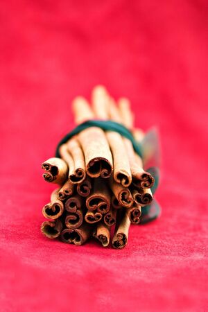 Cinnamon sticks on a red background. Shallow DOF.の写真素材