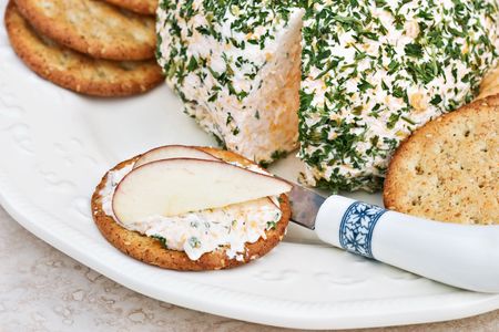 Herb cheese on a sesame cracker with slices of apple. の写真素材