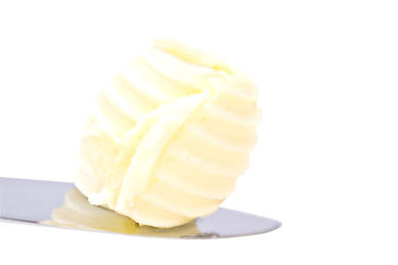 Single perfect butter curl on a knifeの写真素材