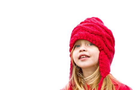 Happy little girl dressed for winter with copy space.の写真素材