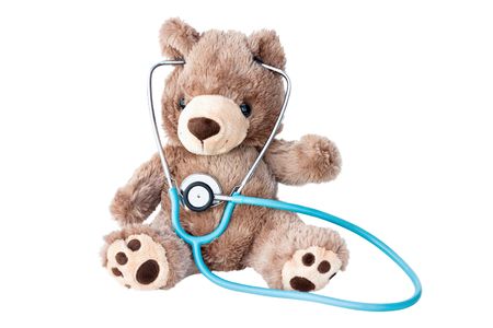 Little teddy bear listens to his heart with a stethoscope.の写真素材