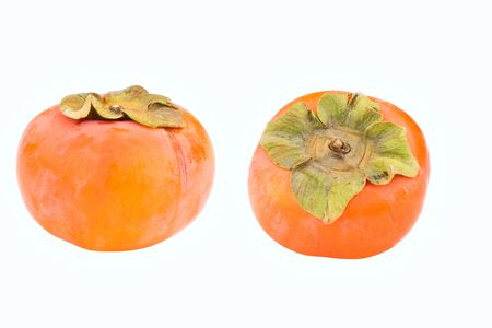 Two persimmons isolated on white showing top and front views. の写真素材