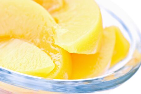Macro of peaches in a glass isolated on whiteの写真素材