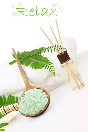 Green bath salts in a wooden spoon with essential oils and white towel. Extreme shallow DOF with selective focus on bath salts. Room for your text.の写真素材